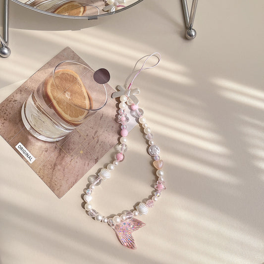 Discover the ocean-inspired Mermaid Beaded Pearl Phone Charm in 4 vibrant colors – a secure, stylish, and versatile Y2K accessory perfect for tech lovers and beach enthusiasts alike!