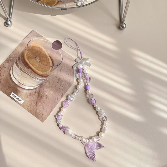 Discover the ocean-inspired Mermaid Beaded Pearl Phone Charm in 4 vibrant colors – a secure, stylish, and versatile Y2K accessory perfect for tech lovers and beach enthusiasts alike!