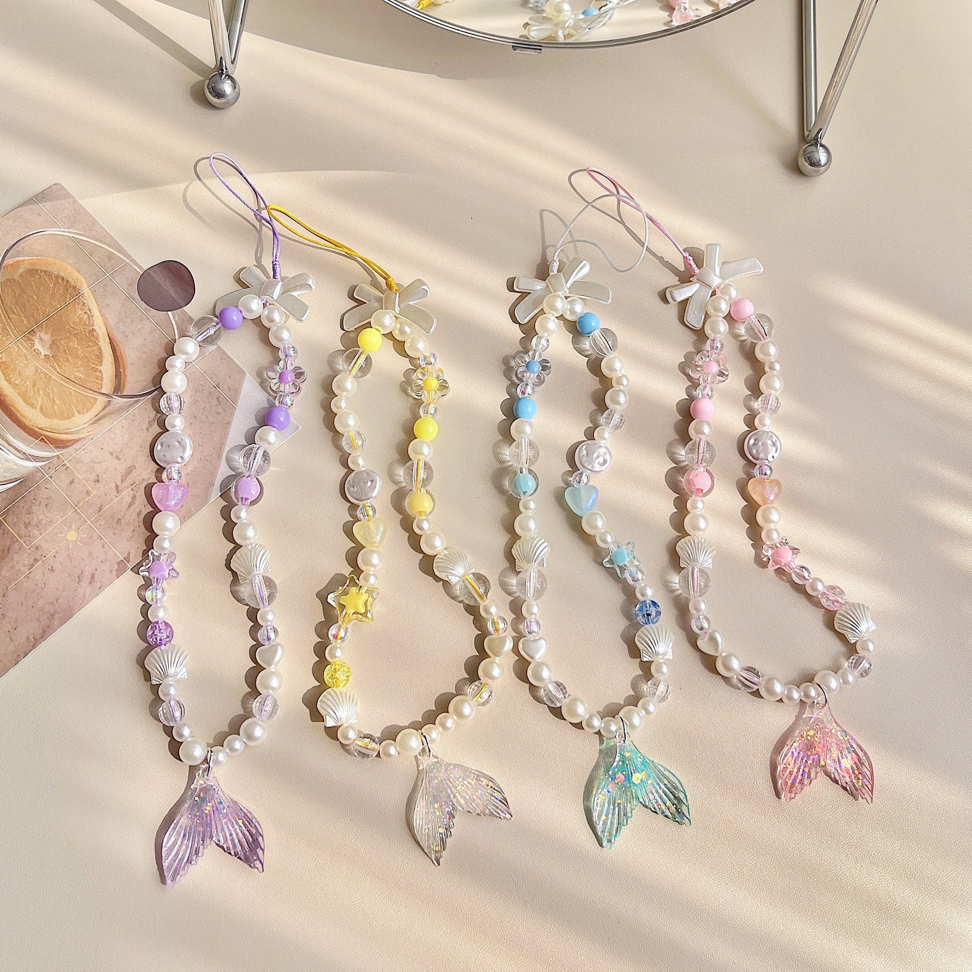 Discover the ocean-inspired Mermaid Beaded Pearl Phone Charm in 4 vibrant colors – a secure, stylish, and versatile Y2K accessory perfect for tech lovers and beach enthusiasts alike!