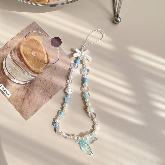 Discover the ocean-inspired Mermaid Beaded Pearl Phone Charm in 4 vibrant colors – a secure, stylish, and versatile Y2K accessory perfect for tech lovers and beach enthusiasts alike!