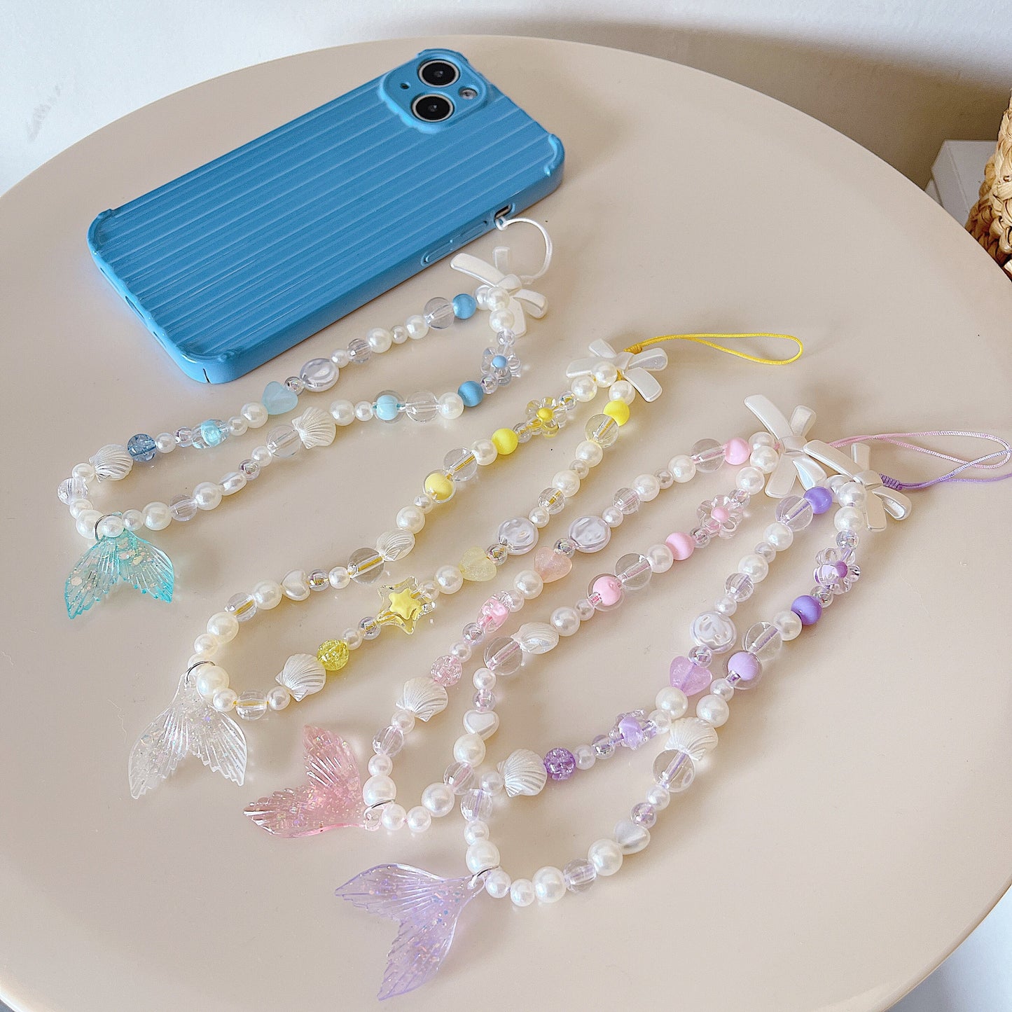 Discover the ocean-inspired Mermaid Beaded Pearl Phone Charm in 4 vibrant colors – a secure, stylish, and versatile Y2K accessory perfect for tech lovers and beach enthusiasts alike!